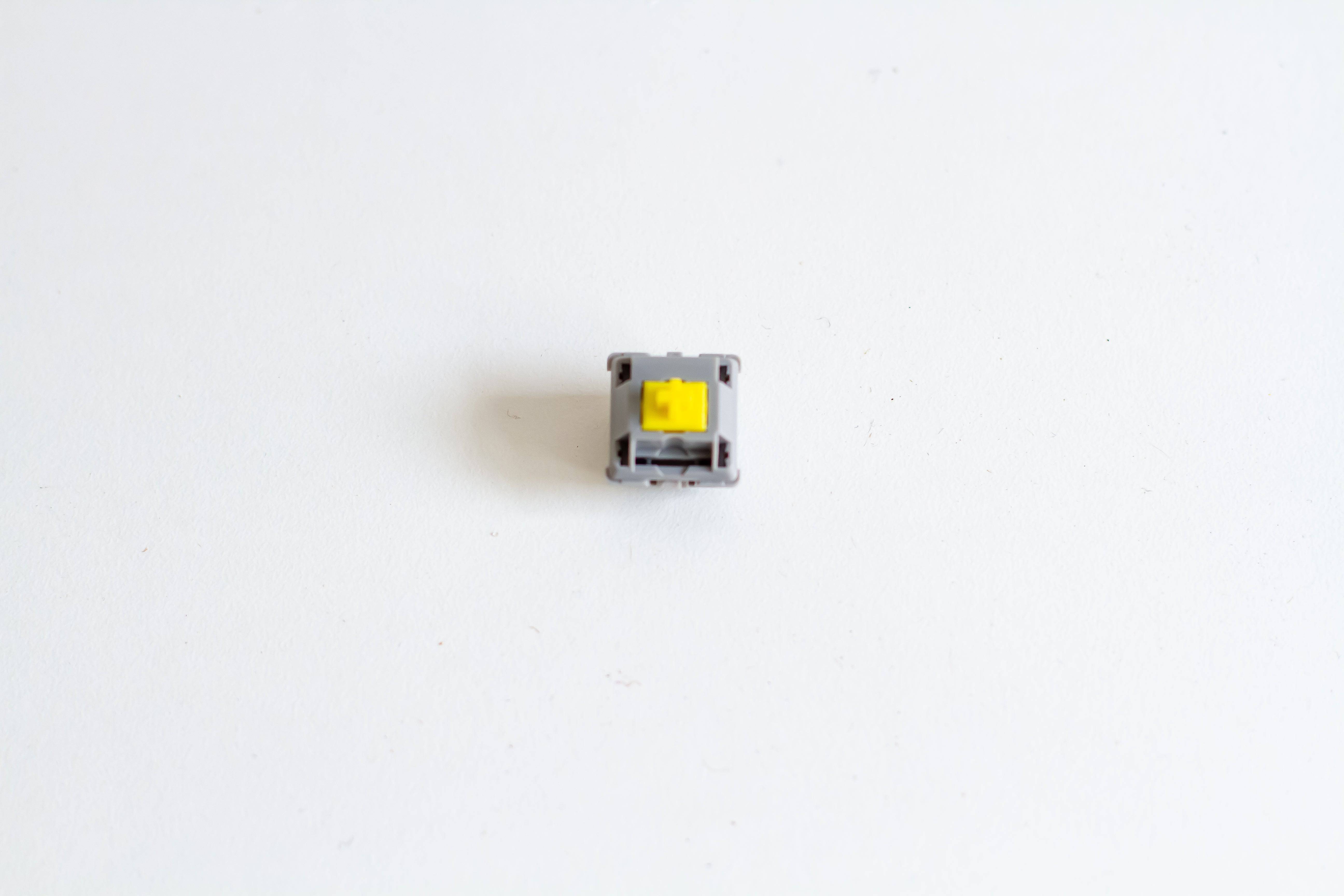 A single JWK Durock tactile T1 POM sunflower mechanical keyboard switch.