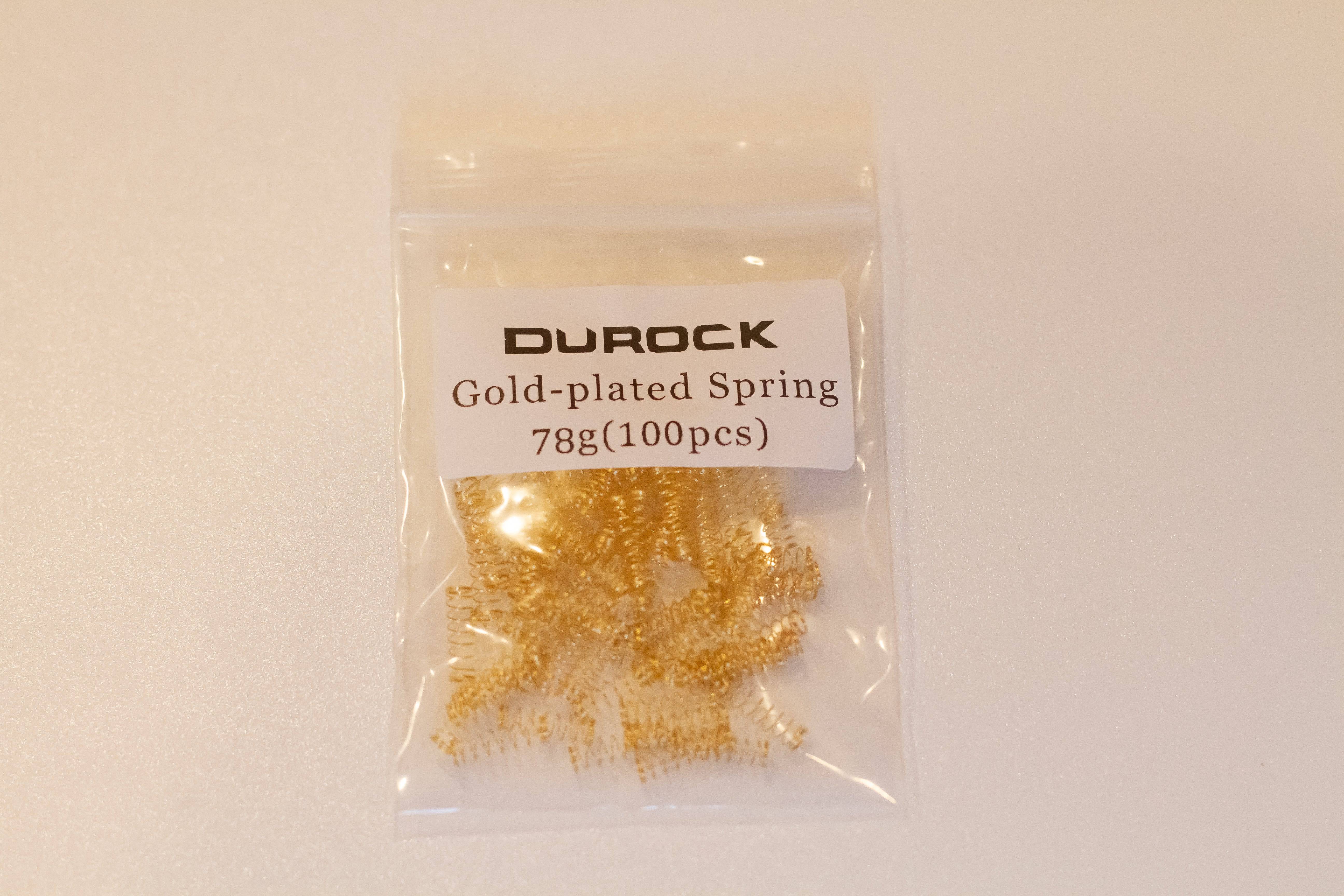 A pack of one hundred gold plated Durock mechanical switch springs with 78 grams of bottom out weight.