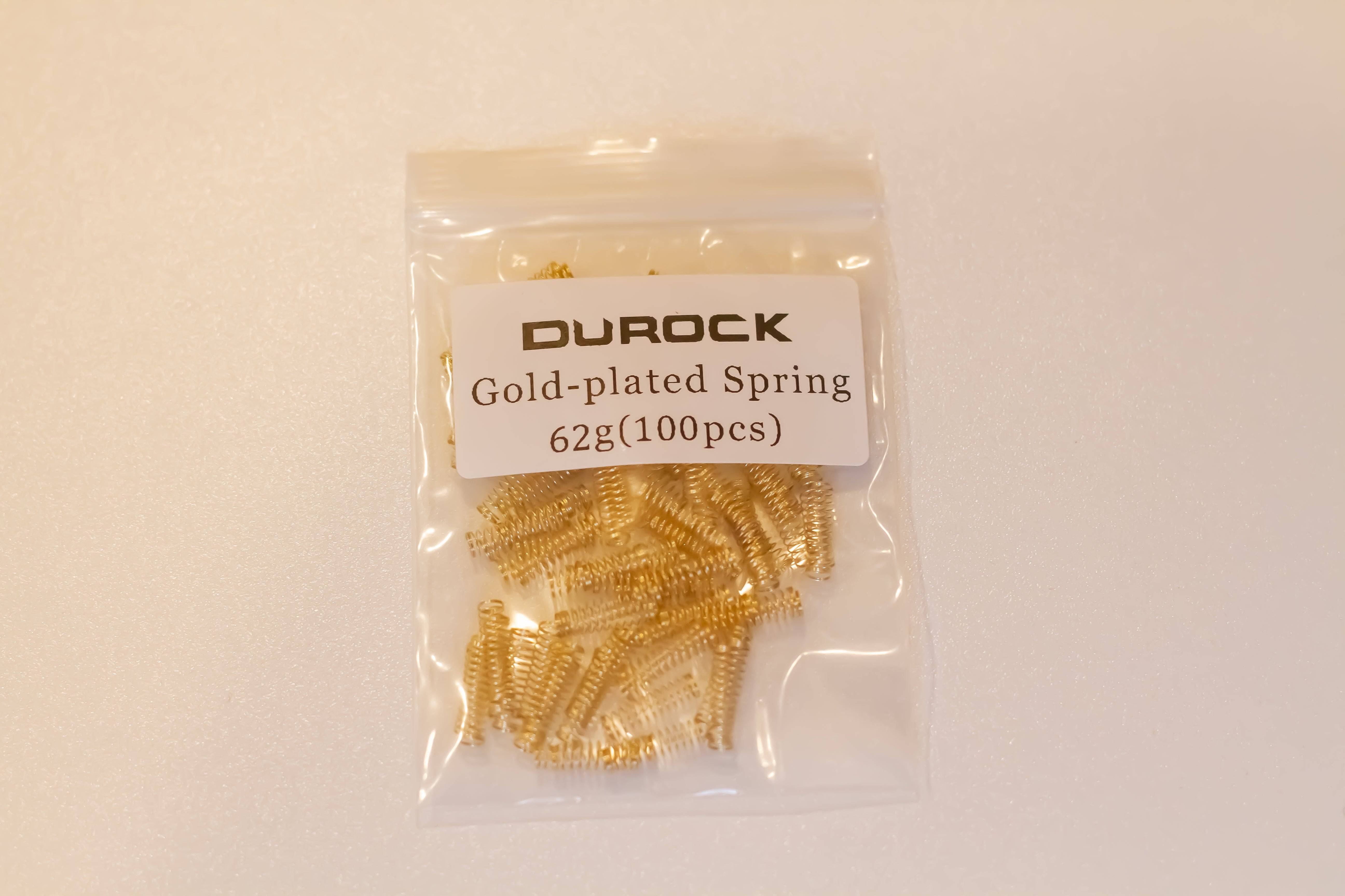 A pack of one hundred gold plated Durock mechanical switch springs with 62 grams of bottom out weight.