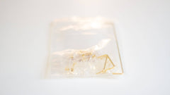 Bag of clear Durock V2 screw-in stabilizers with gold wires, gold screws, and red screw dampener pads for DIY custom mechanical keyboards.