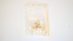 Bag of clear Durock V2 screw-in stabilizers with gold wires, gold screws, and red screw dampener pads for DIY custom mechanical keyboards.