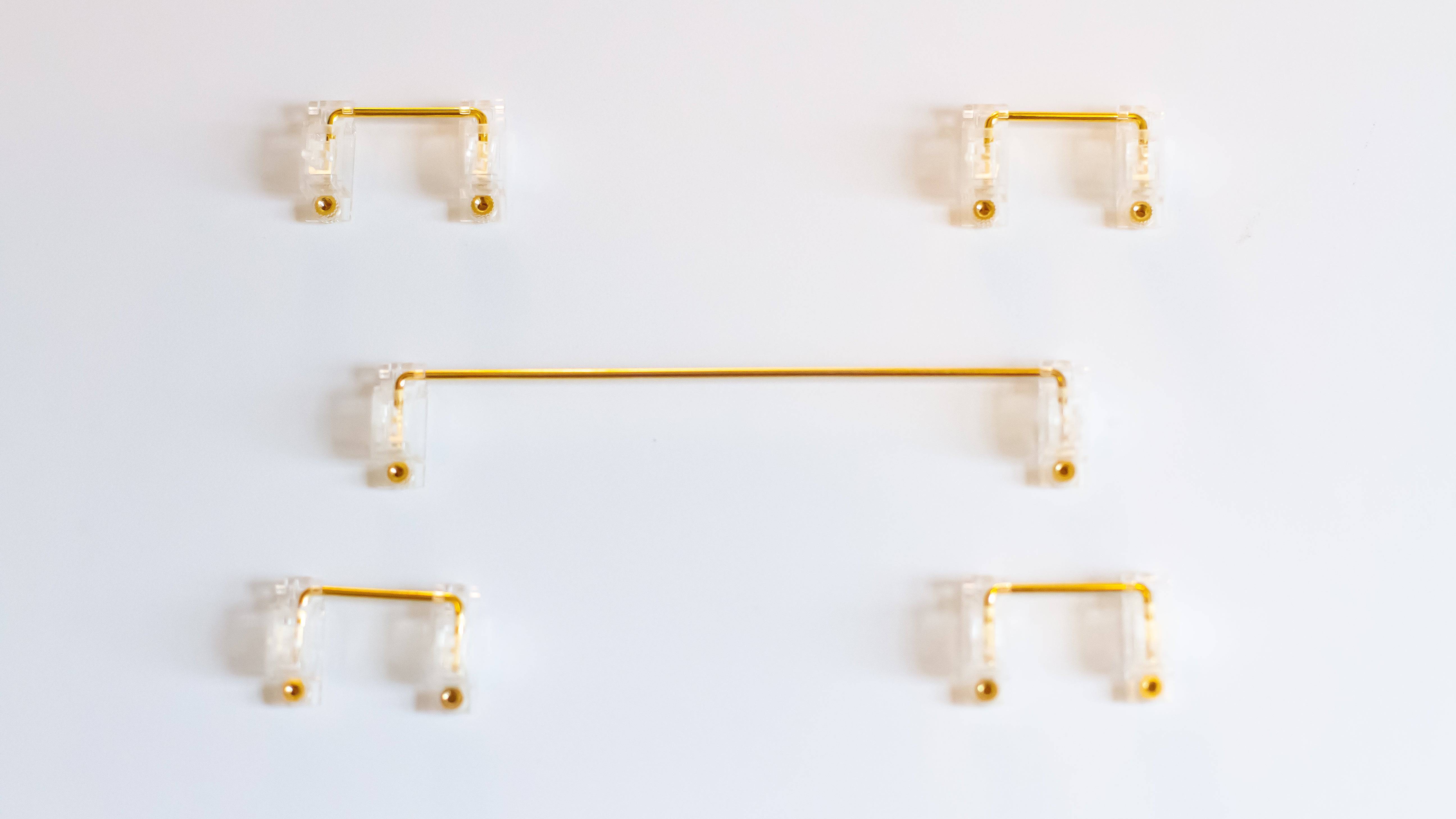 Clear Durock V2 stabilizers with gold wires for custom DIY mechanical keyboards.
