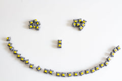 A batch of JWK Durock POM Tactile T1 sunflower mechanical switches arranged in a smiling face.