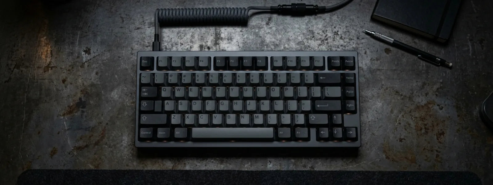 Dark grey Freebird75 75% custom mechanical keyboard kit on an industrial metal desk